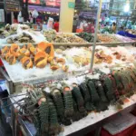 Fresh seafood displayed on ice at a fish market in Patong, Thailand
